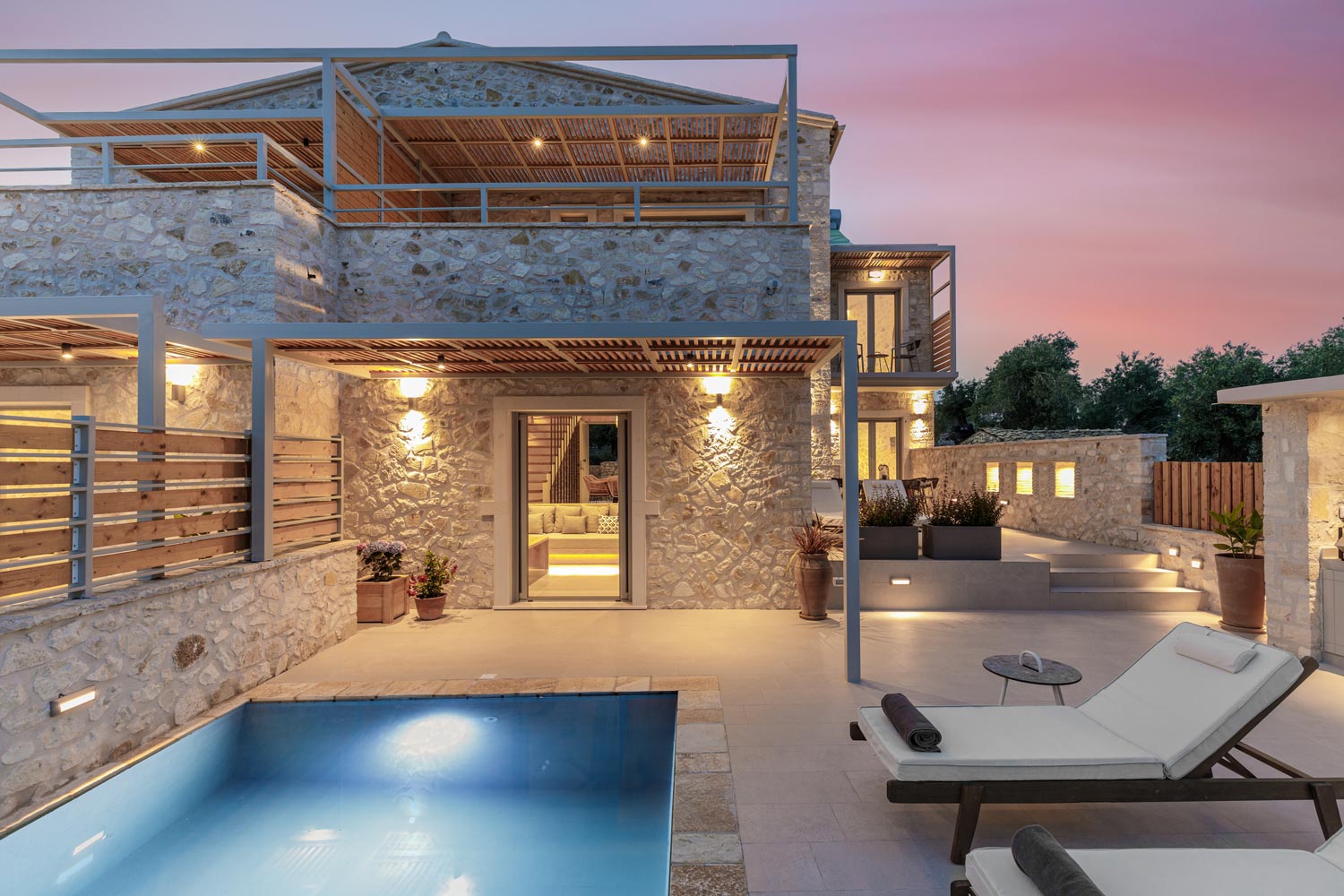 Armonia I lit at dusk, with plunge pool and stone façade